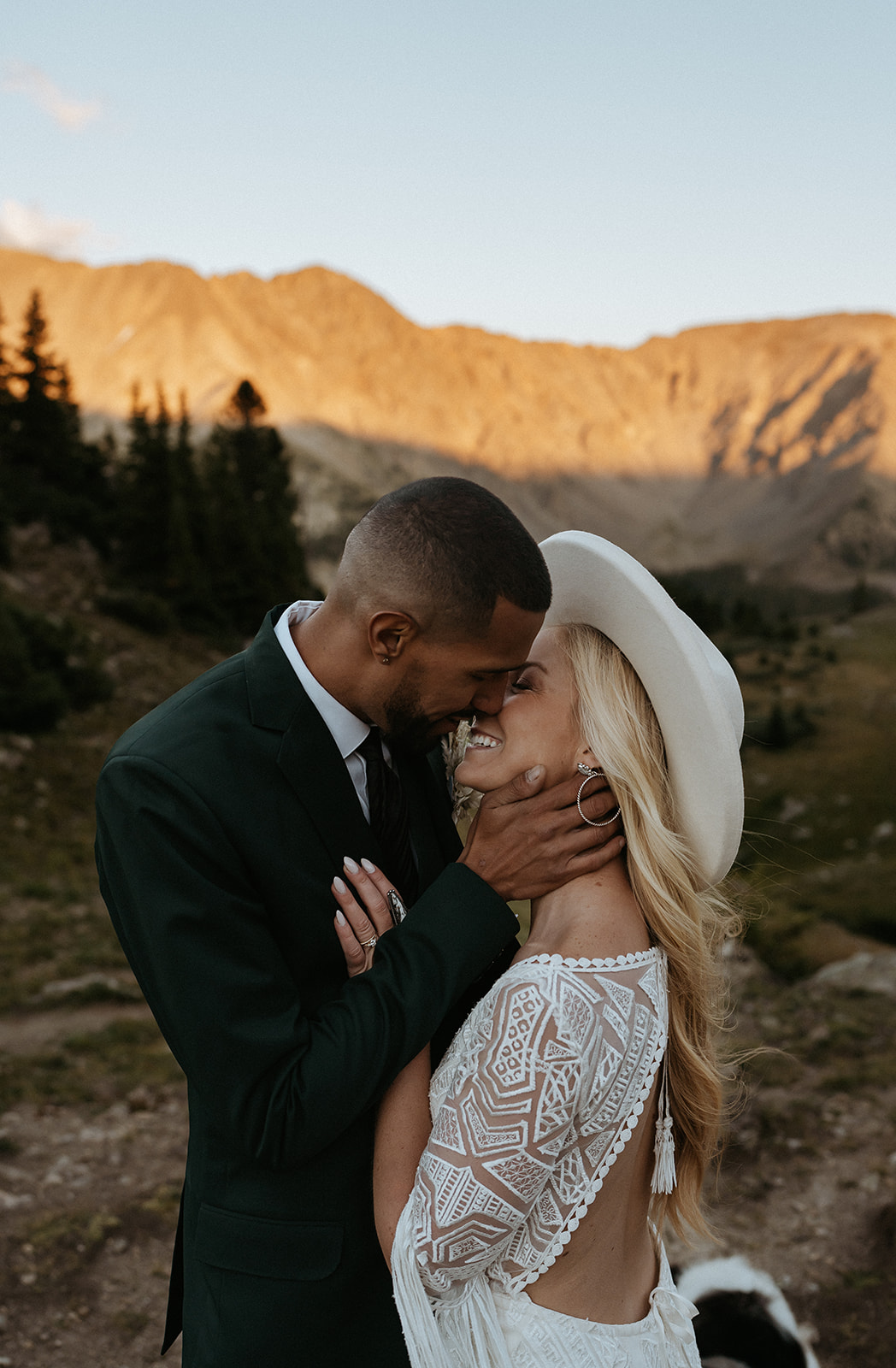 Newlyweds lean in for a kiss at sunset during their Hoosier Pass Elopement
