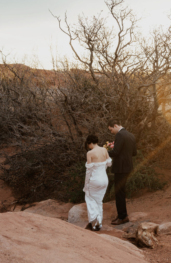 Bride and groom walking along the rocks in Garden of The Gods for their Colorado Springs elopement