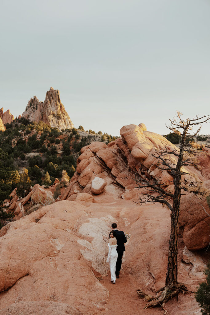 Bride and groom walking along the rocks in Garden of The Gods for their Colorado Springs elopement