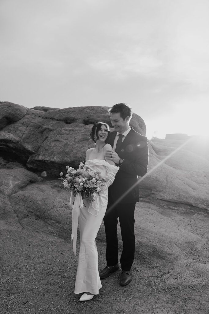 Black and white photo of a bride and groom posing for their Colorado springs elopement portraits in Garden of The Gods.