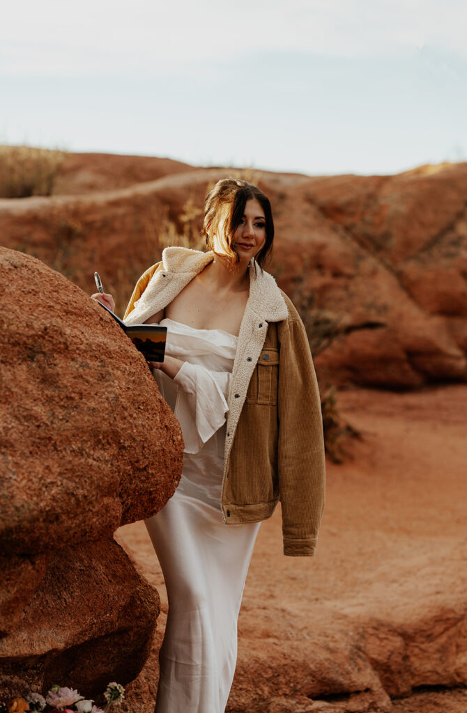 Bride wearing a jacket and writing her personal vows