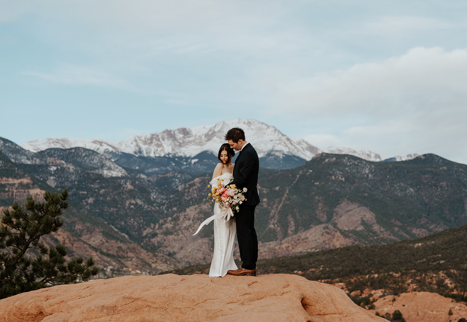 Bride and groom portraits from their Colorado Spring elopement at Garden of The Gods with mountains in the background