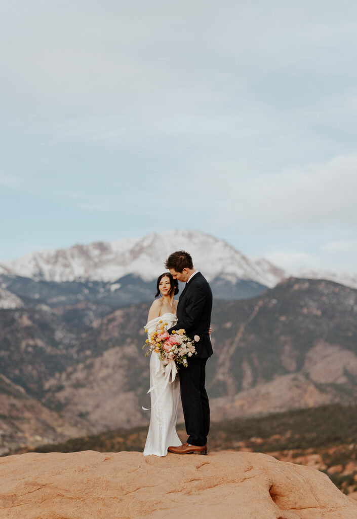 Bride and groom portraits from their Colorado Spring elopement at Garden of The Gods with mountains in the background