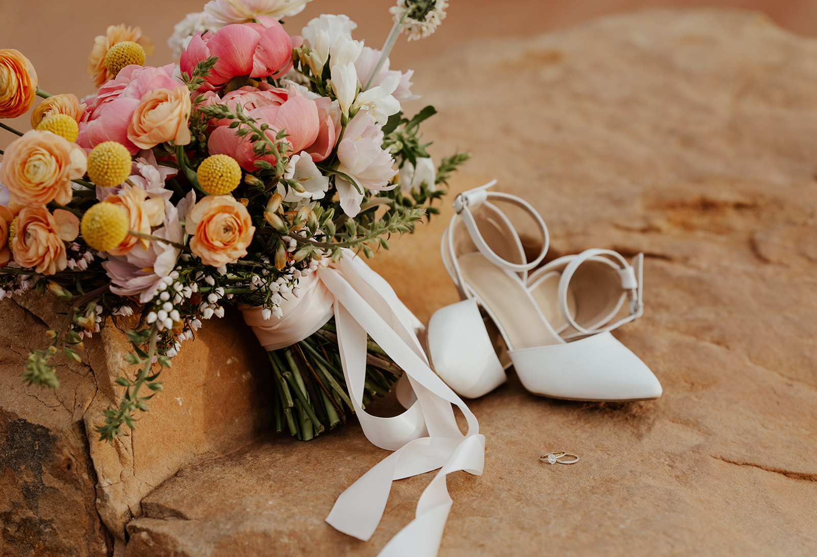 Elopement details from a Colorado Spring elopement with a spring wedding bouquet, brides heels, and rings. 