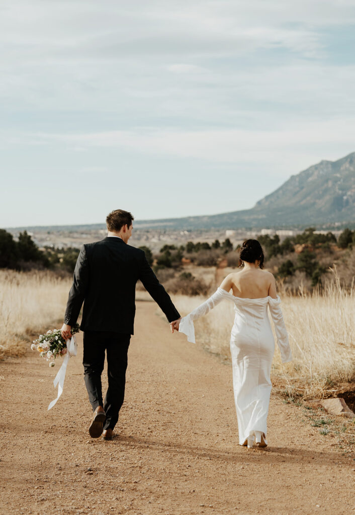 Bride and groom walking the paths in Garden of The Gods