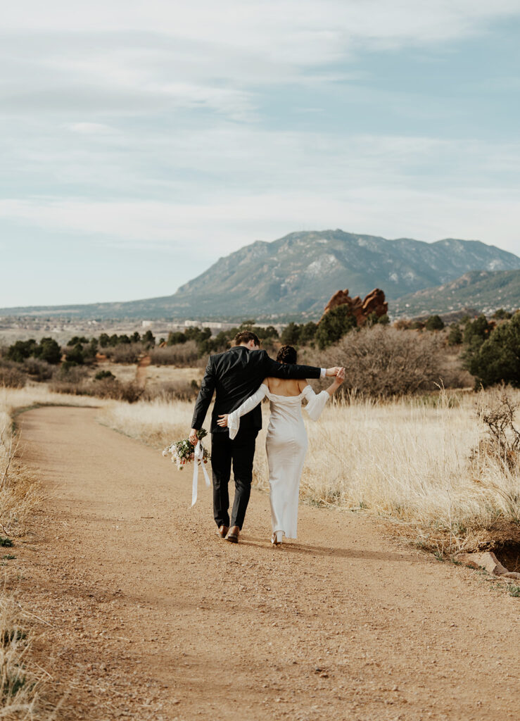 Bride and groom walking the paths in Garden of The Gods