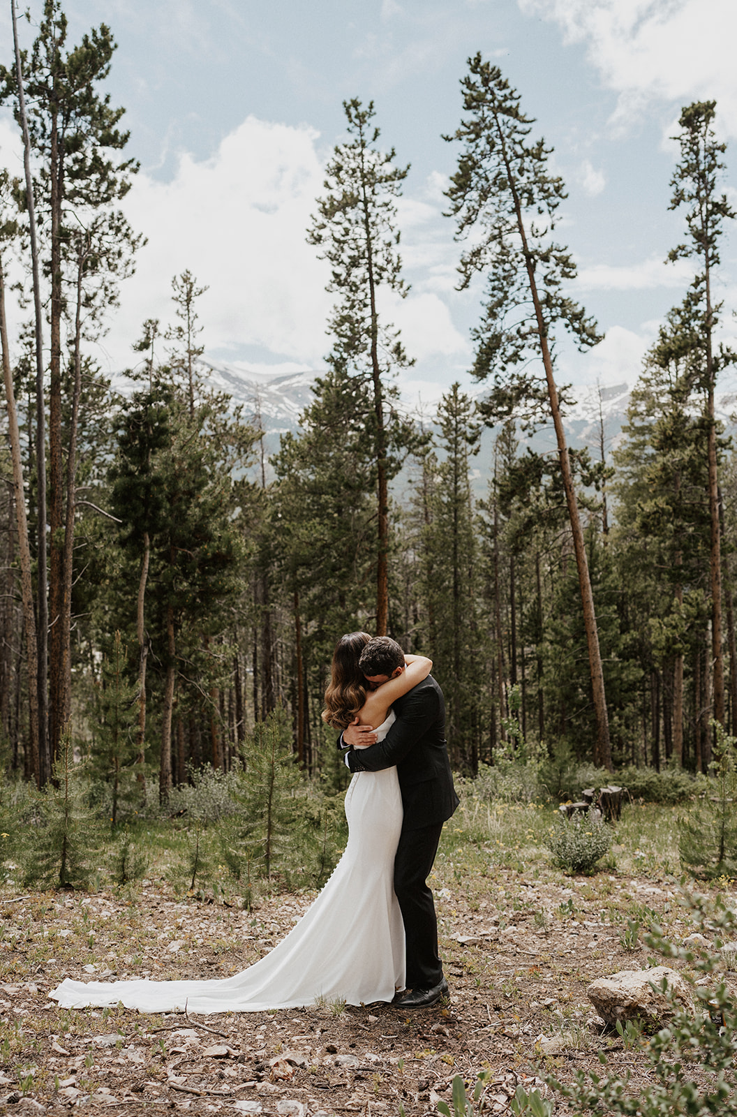 Bride and groom hugging after sharing their first look during their Airbnb elopement in Breckenridge, Colorado at Northwoods