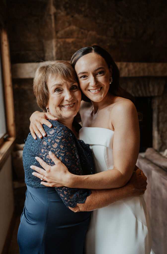 Bride and her mother hugging