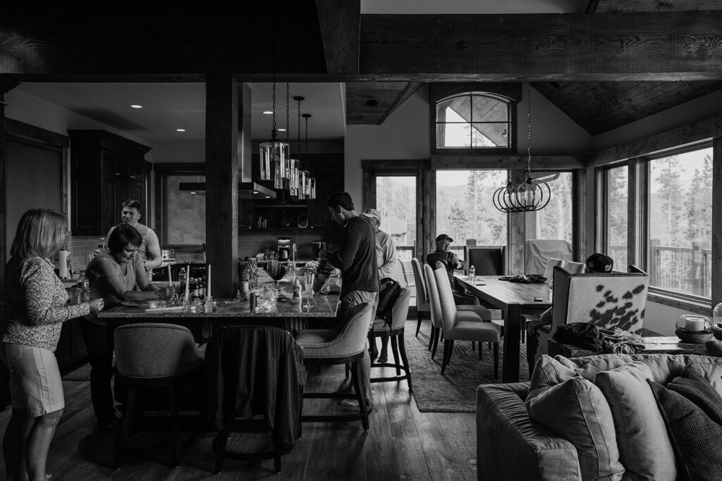 Black and white photo of a groom and his family getting ready at their Airbnb rental - Northwoods in Breckenridge, Colorado