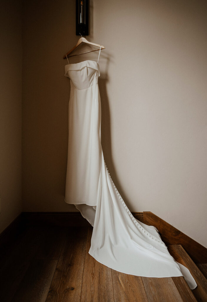 Brides wedding dress hanging at an Airbnb rental