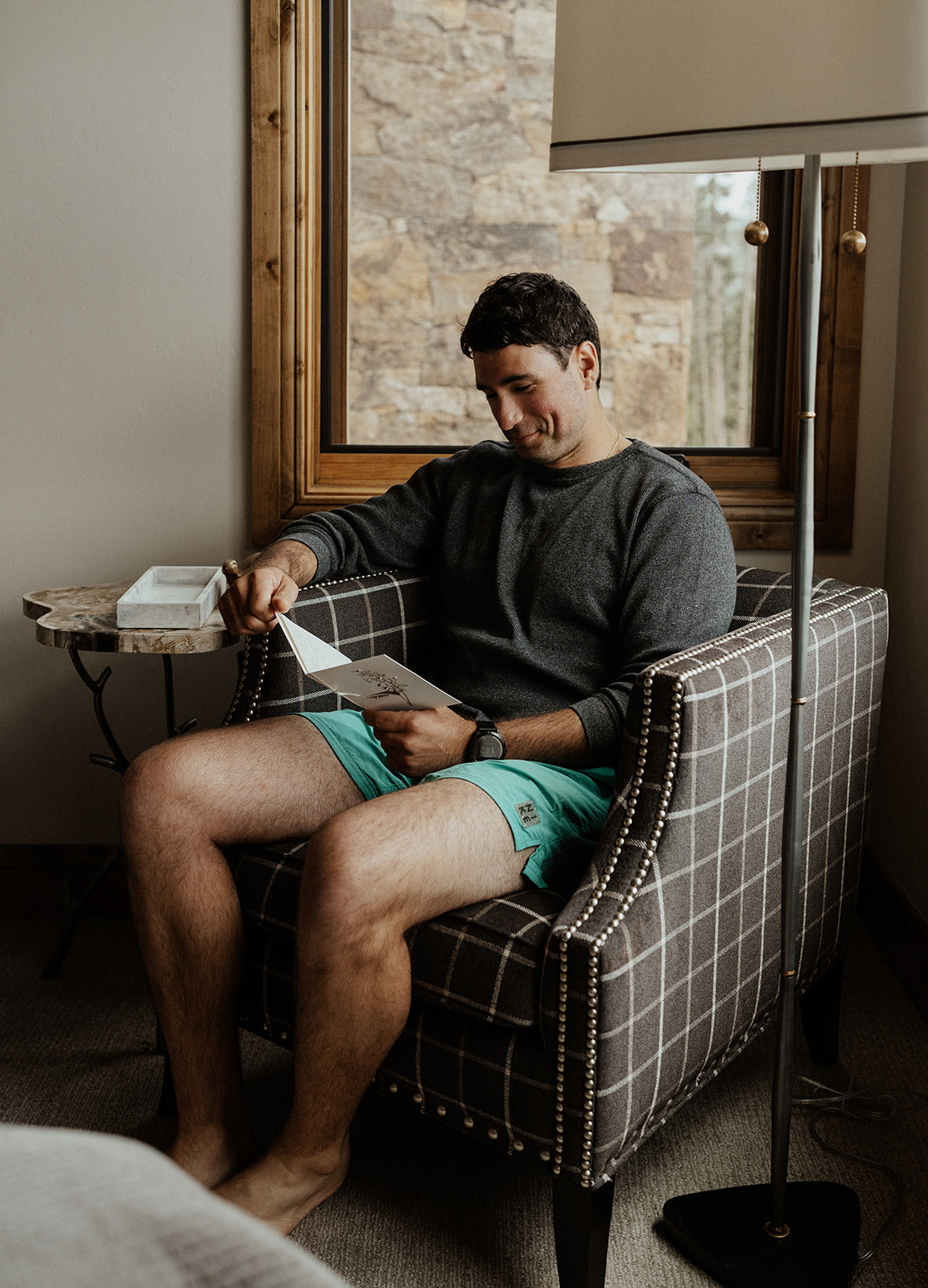 Groom reading a card from his bride to be at Northwoods in Breckenridge, Colorado