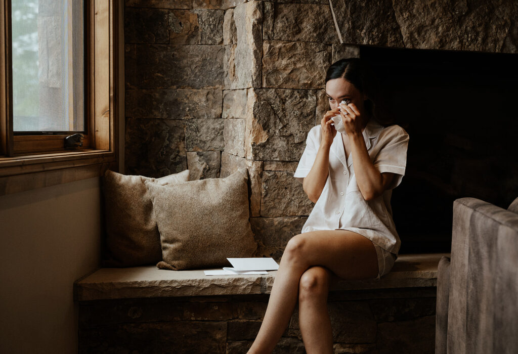 Bride crying as she reads a letter from her soon to be husband