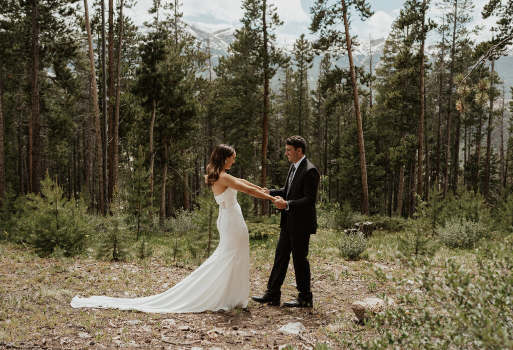 Bride and groom sharing their first look during their Airbnb elopement in Breckenridge, Colorado at Northwoods