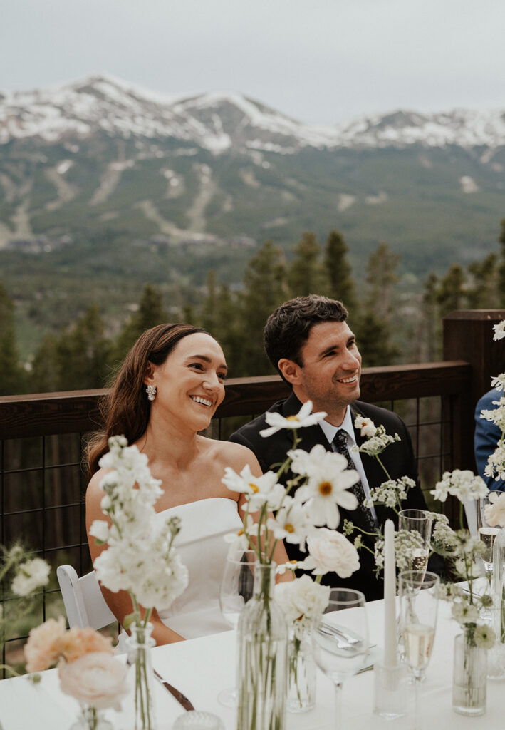 Bride and groom smiling during their Airbnb elopement reception at Northwoods in Breckenridge, Colorado