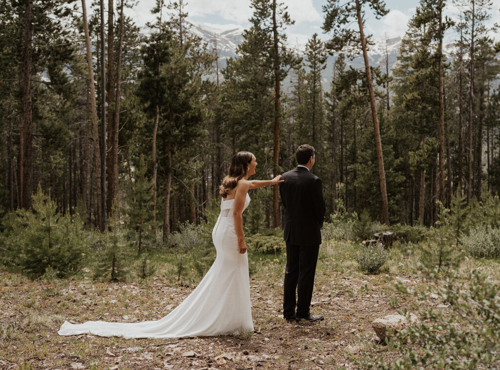 Bride and groom sharing their first look during their Airbnb elopement in Breckenridge, Colorado at Northwoods