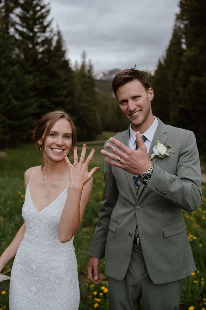 Bride and groom showing off their rings