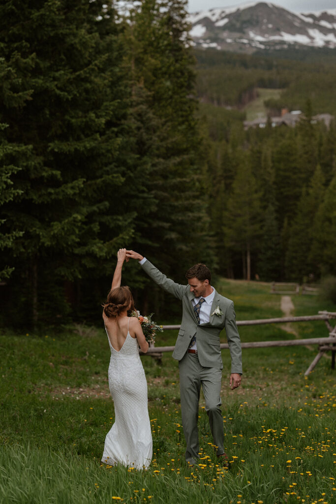 Groom twirling his bride around 