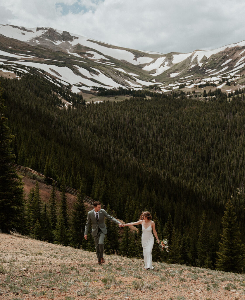 Bride and grooms walking up Peak 9 for their Colorado mountain elopement in Breckenridge