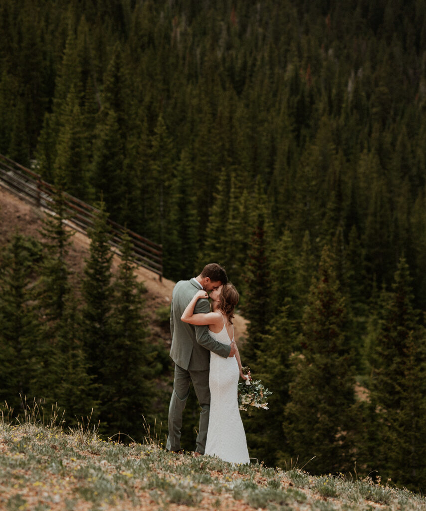 Bride and groom kissing each other during their Colorado mountain elopement on Peak 9 in Breckenridge