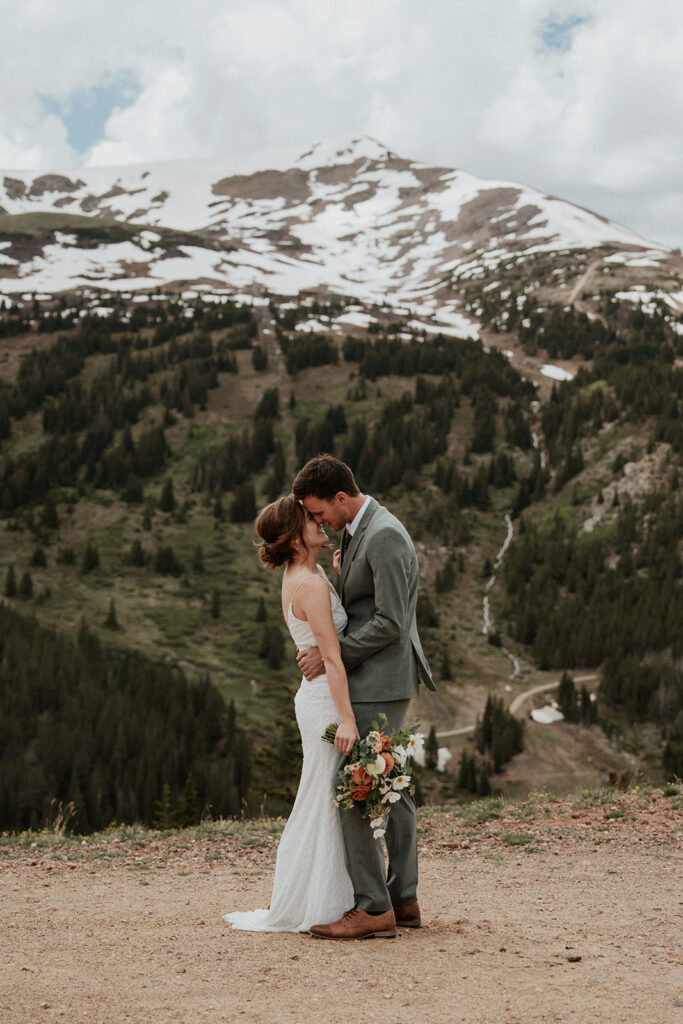 Bride and groom kissing during their Colorado mountain elopement on Peak 9 in Breckenridge