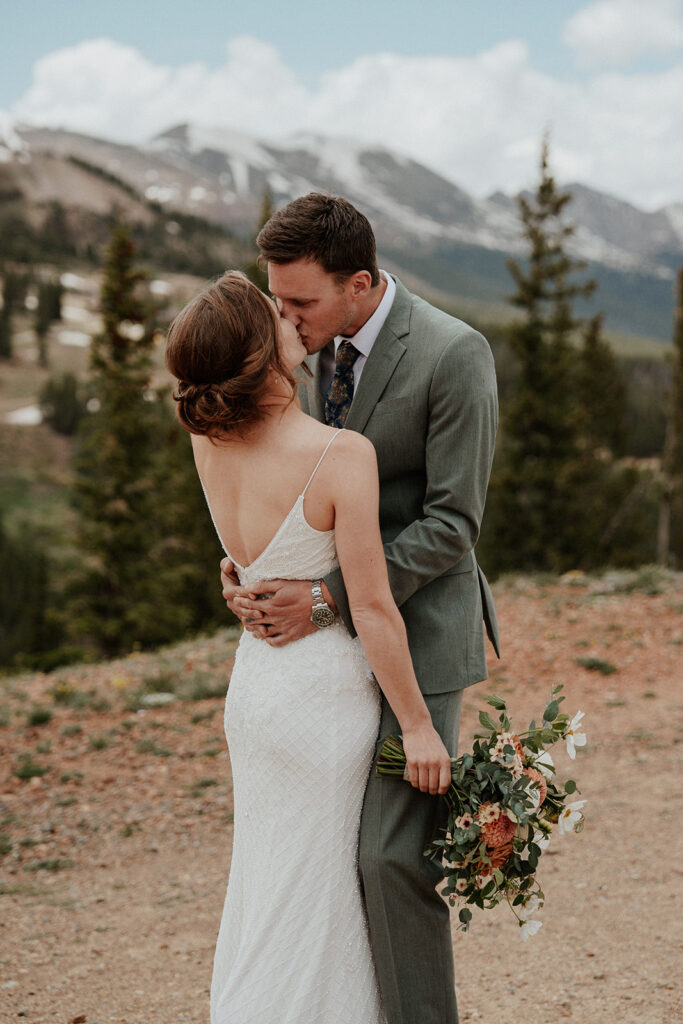 Bride and groom kissing during their Colorado mountain elopement on Peak 9 in Breckenridge