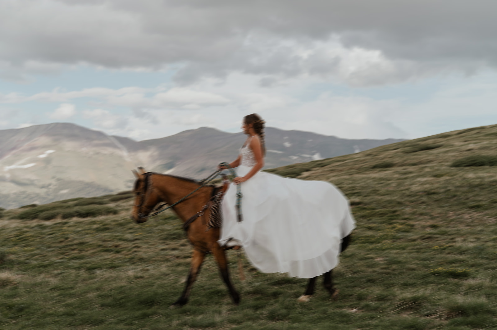 Bride riding horseback for her intimate Hoosier Pass elopement in Colorado