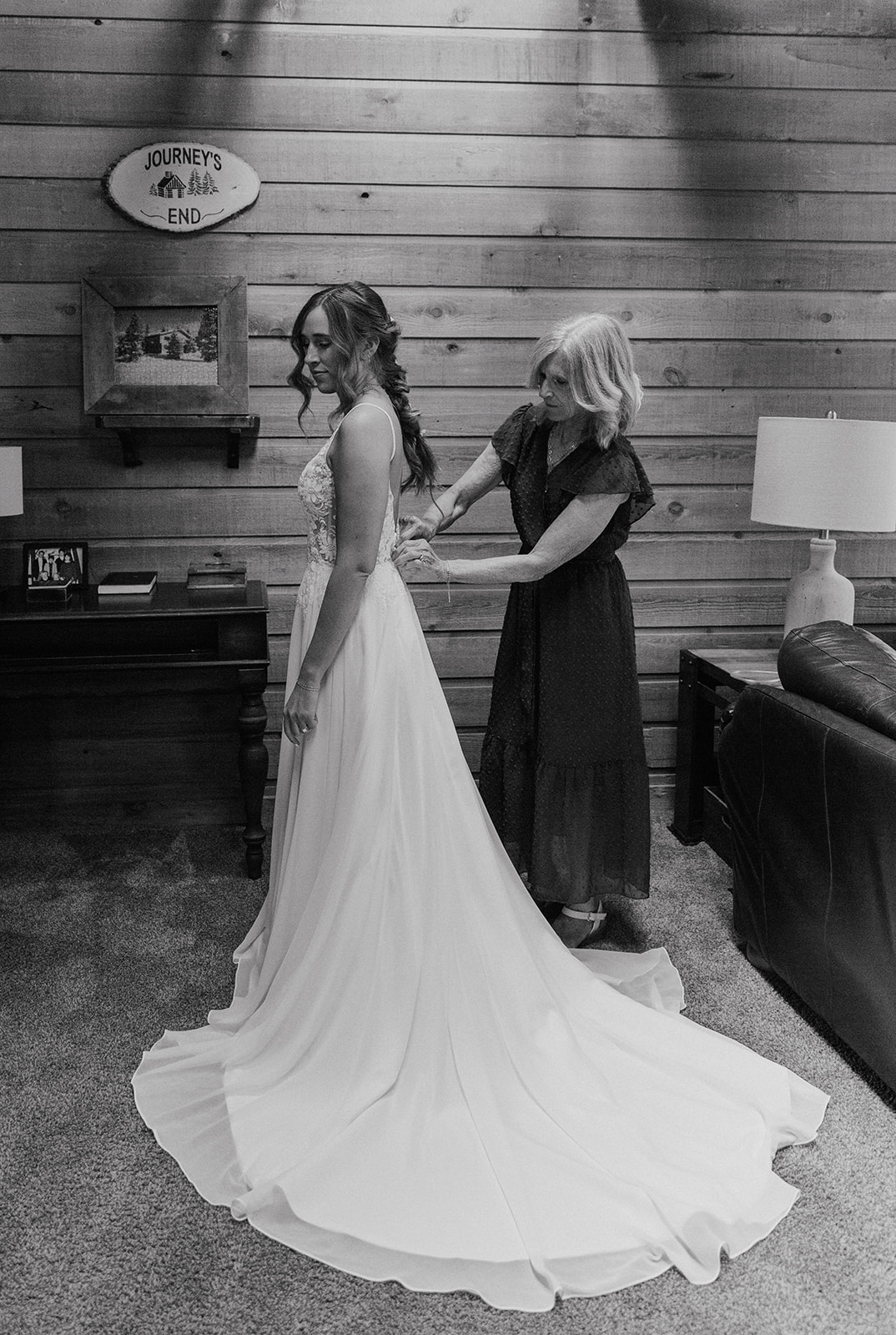 Black and white photo of a bride getting ready with her mother