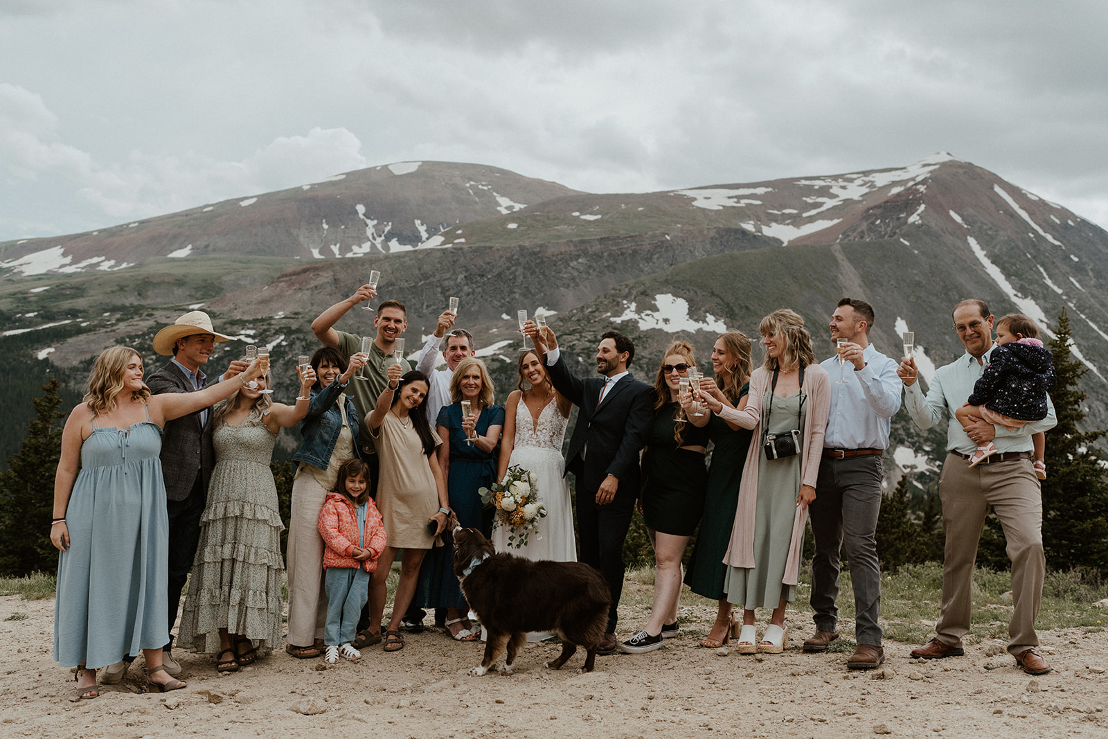 Bride, groom, and their family celebrating with champagne during their Hoosier Pass elopement in Colorado