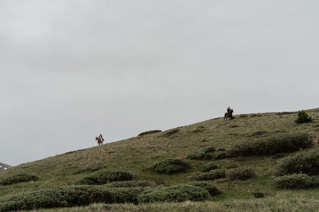 Bride and groom riding in the Colorado mountains at Hoosier Pass