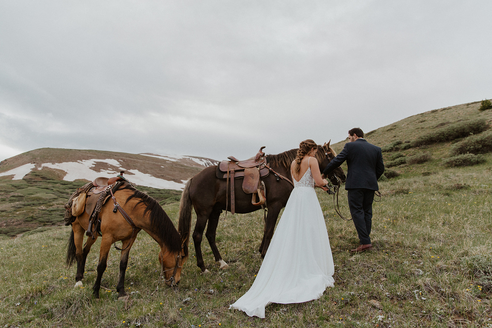 Bride and groom tending to their horses during their intimate horseback Hoosier Pass elopement in Colorado