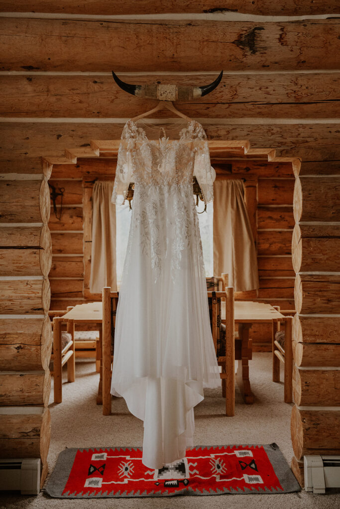 Brides dress hanging in their Telluride Colorado cabin