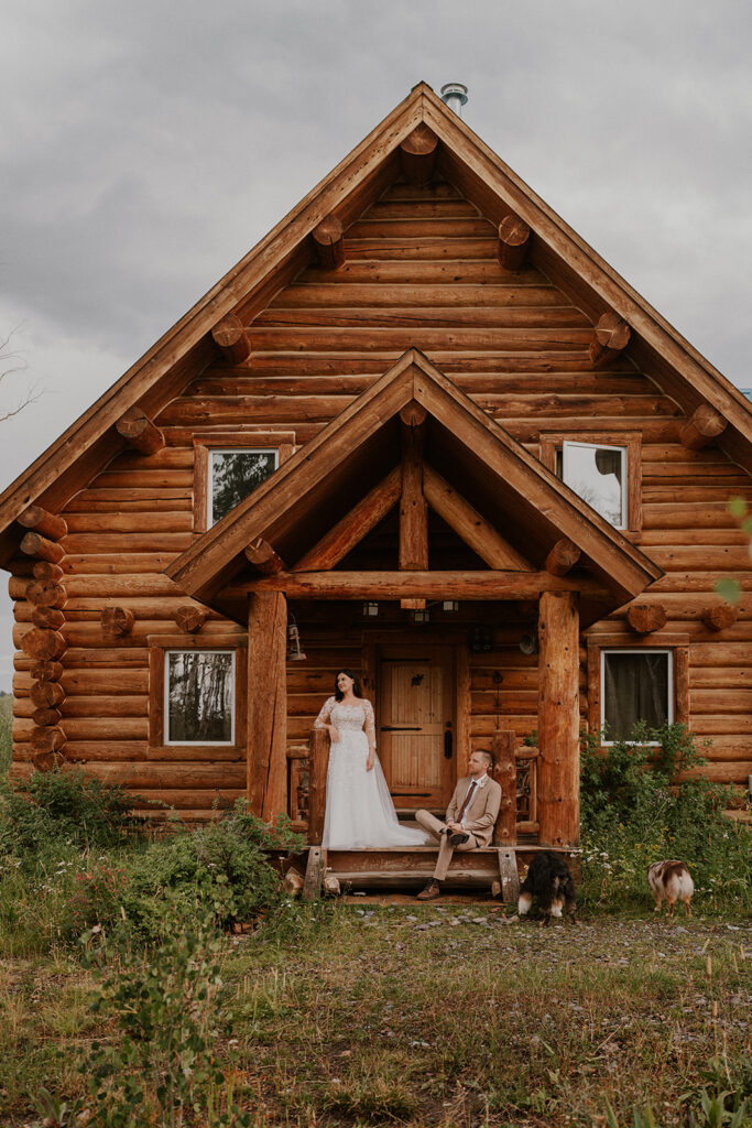 Bride and groom posing in front of their cabin on Last Dollar Road in Telluride, Colorado