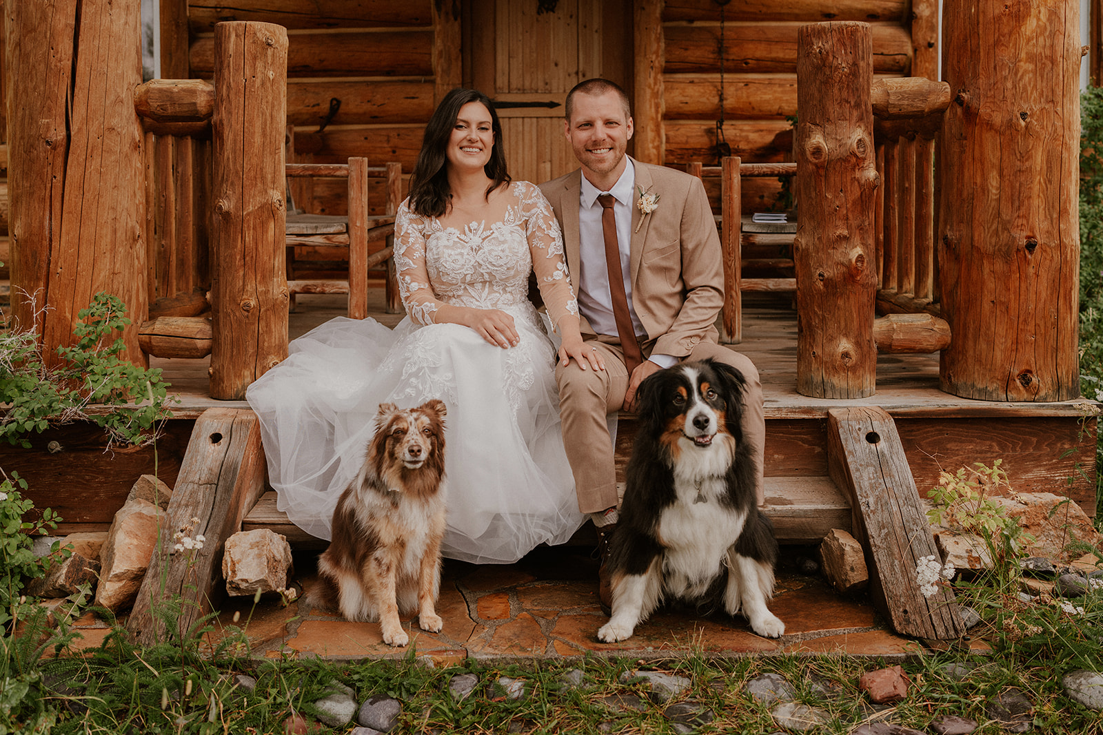 Bride and groom posing with their two dogs at their cabin for their Telluride Colorado elopement on Last Dollar Road