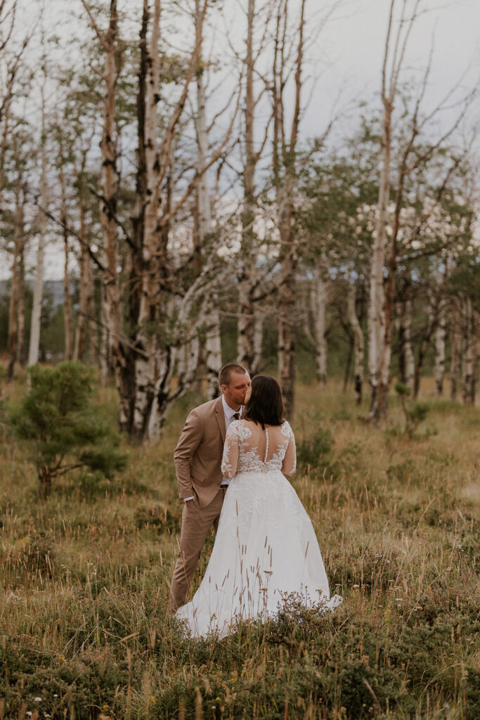 Bride and groom kissing during their private vows