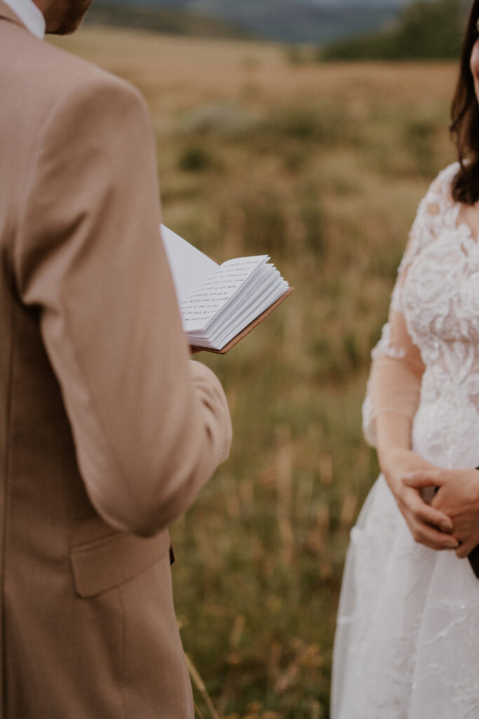 Groom reading his vows to his bride