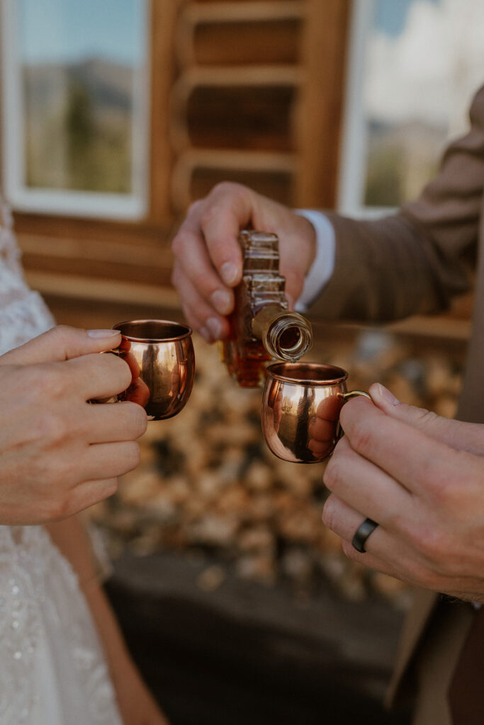 Bride and groom pouring maple syrup into glasses