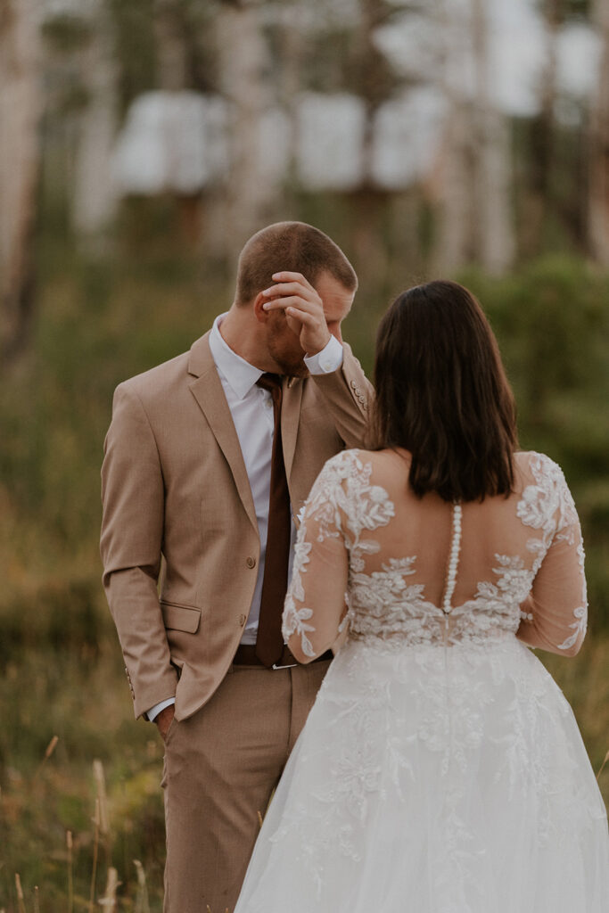 Groom getting emotional as a bride reads her vows to him