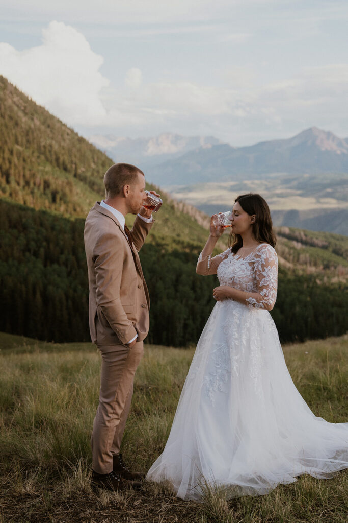 Bride and groom drinking bourbon in celebration of their Telluride, Colorado elopement