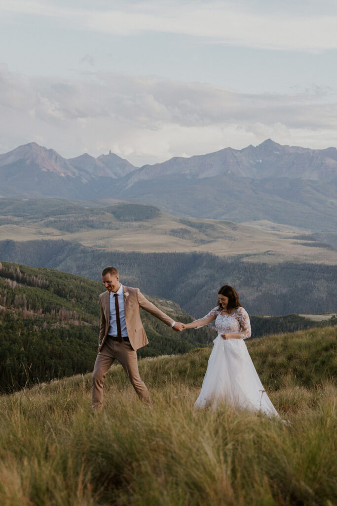 Bride and groom walking through the mountains during their Telluride, Colorado elopement