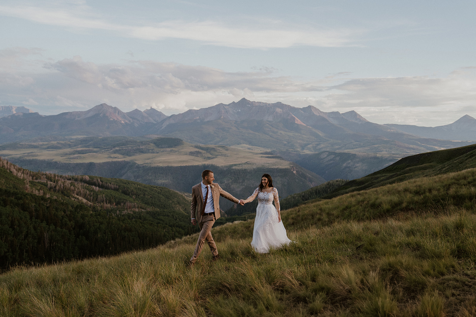 Bride and groom walking through the mountains during their Telluride, Colorado elopement