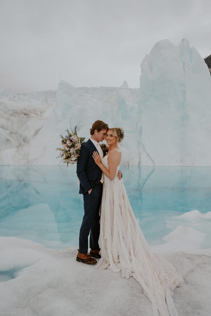 Bride and groom posing at Knik Glacier in Alaska