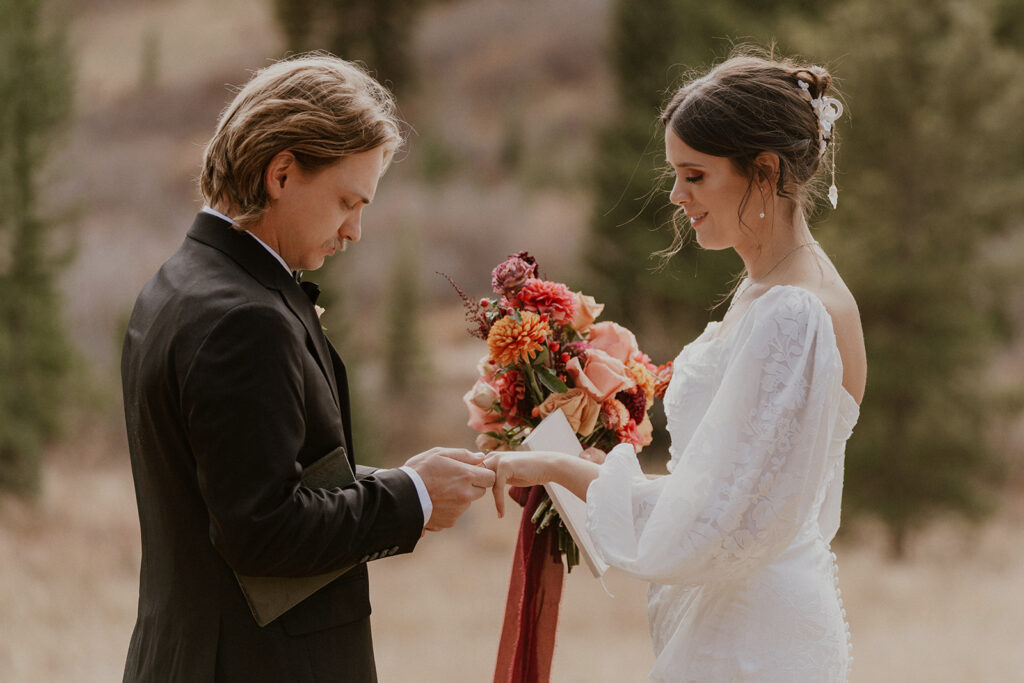 Bride and groom exchanging rings during their intimate Boreas Pass elopement ceremony