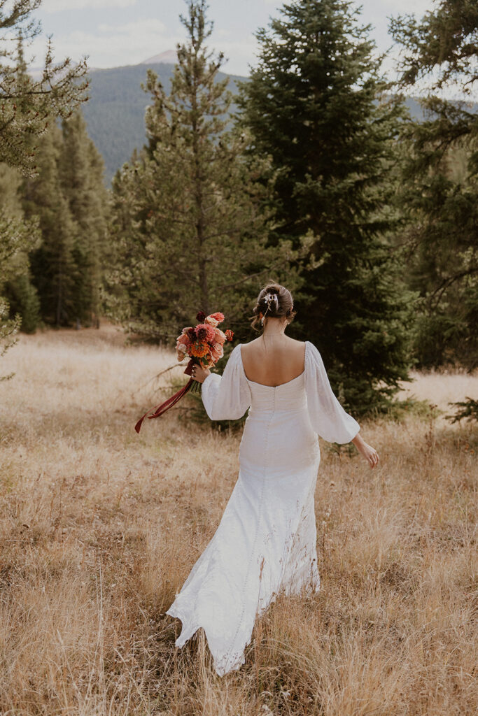 Bride walking in a field in Boreas Pass