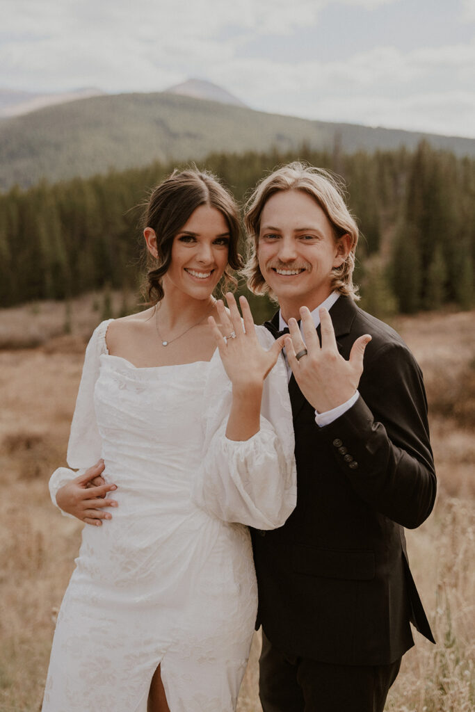 Bride and groom showing off their wedding rings