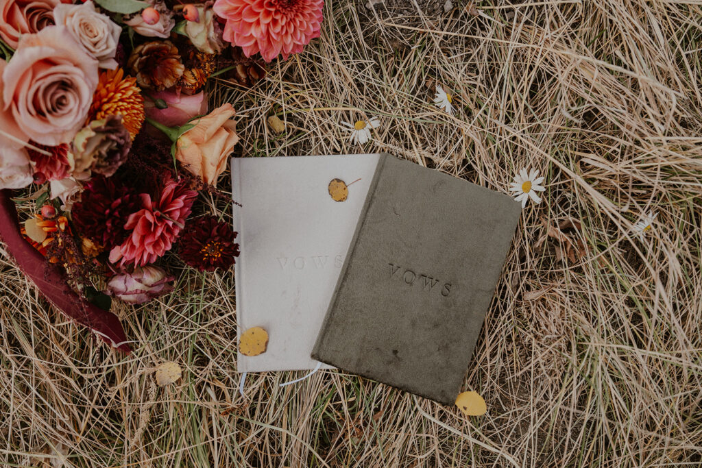 Flatlay detail shot of an elopement bouquet and vow books