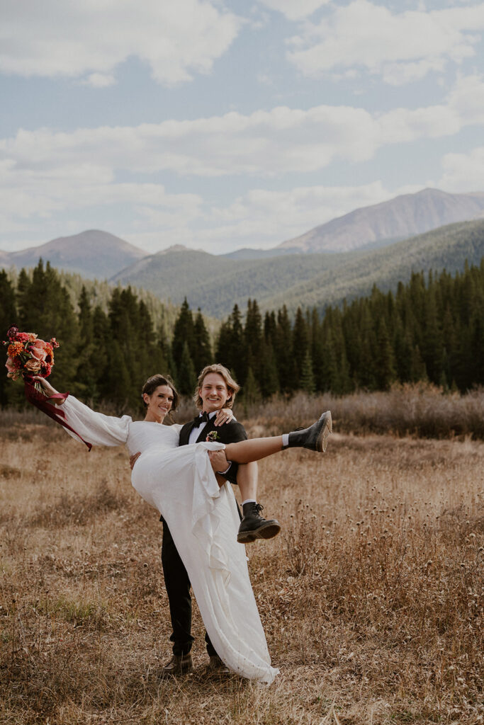 Bride and groom posing for their portraits at Boreas Pass in Colorado