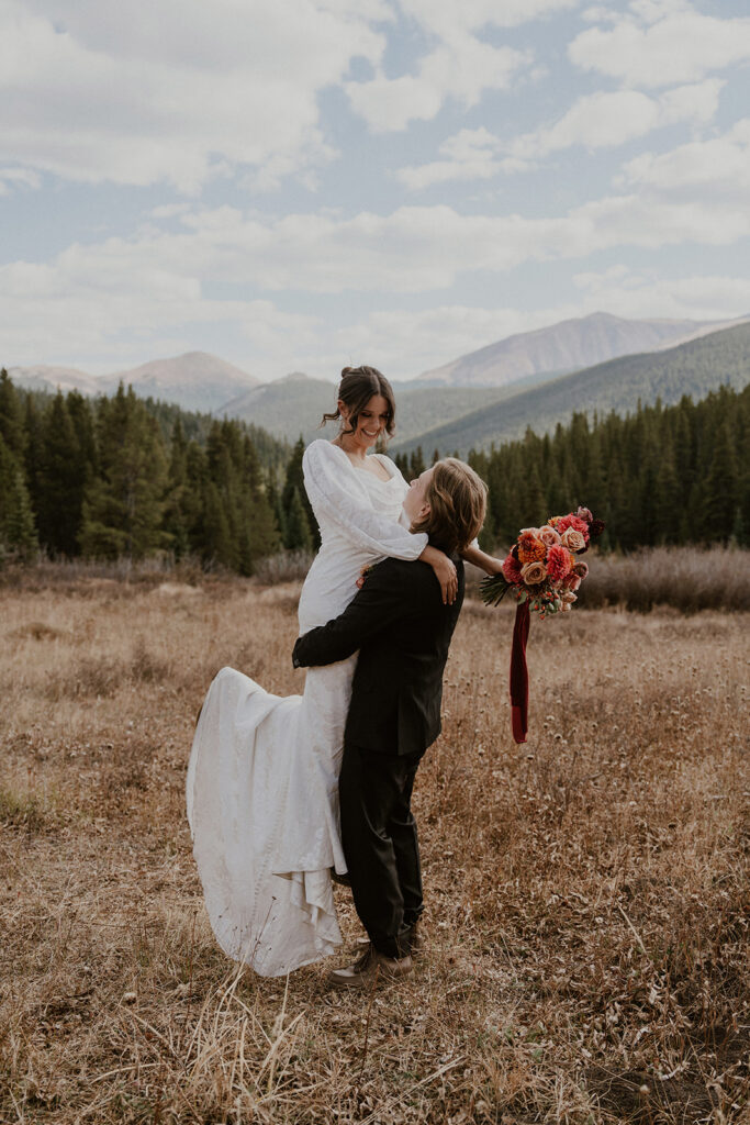 Groom picking up his bride during their Boreas Pass Colorado elopement portraits