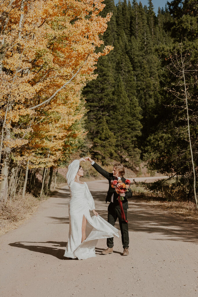 Bride and groom dancing in the road for their Boreas Pass Colorado elopement photos