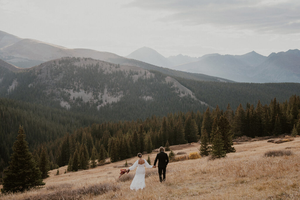 Bride and groom walking through the mountains for their Colorado elopement