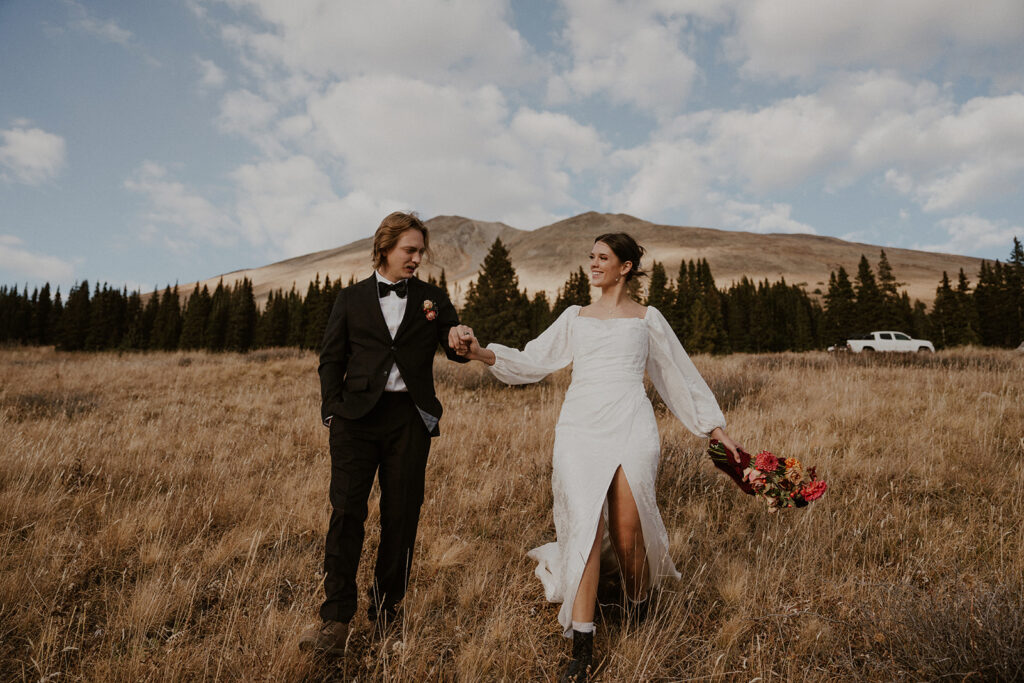 Bride and groom walking through the mountains for their Colorado elopement